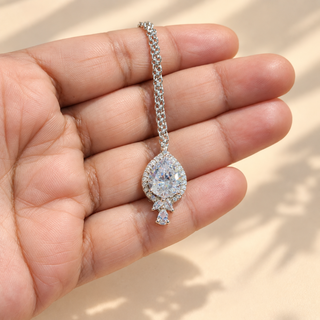 Clara CZ diamond simulant silver finish maang tikka hand-held close-up