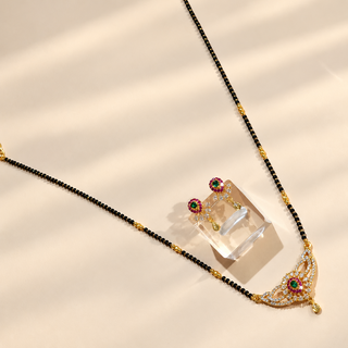 Charlotte multicolour black bead mangalsutra necklace and green pink CZ earrings angled flat lay