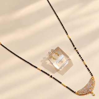 Charlotte white diamond look mangalsutra necklace and matching earrings styled diagonally
