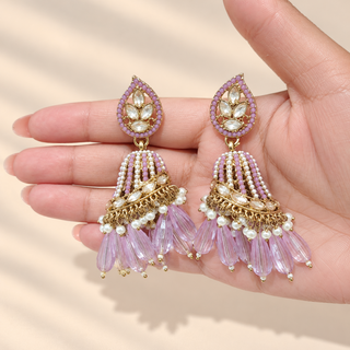 Adeline light purple lavender Indian polki jhumka earrings in hand showing clear polki-style stones and lilac drop beads
