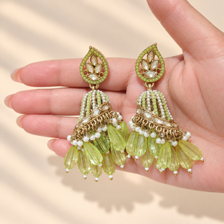 Adeline pastel green Indian polki jhumka earrings held in hand showing mint green and white beaded domes and light green drops