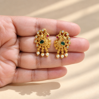 Beatrix Indian imitation Kemp stud earrings held in hand size reference