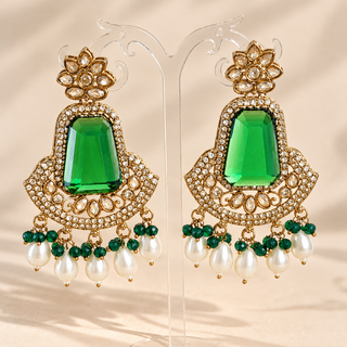 Beatrix dark green polki earrings with gold finish emerald green stones and white pearl drops on display