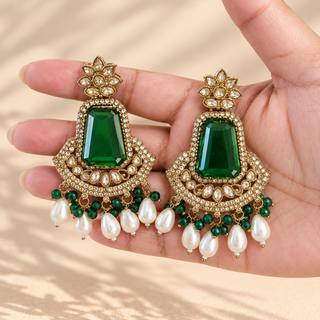 Beatrix dark green polki statement earrings 7.5 cm with green beads and pearl drops held in hand