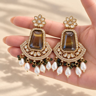 Beatrix green polki earrings 7.5 cm with gold finish and white pearl drops photographed in hand