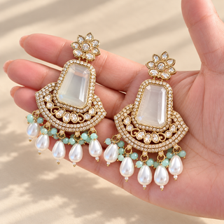Beatrix mint green polki earrings 7.5 cm with pearl drops held in hand