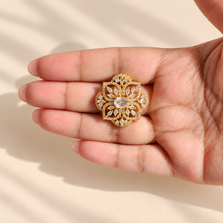 Charlotte ornate gold finish diamond simulant statement ring photographed in hand