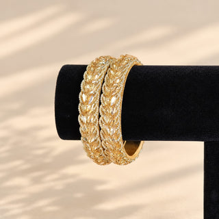 Cressida gold finish Indian kada bangle pair champagne stones on black display stand