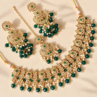 Dovey emerald green polki necklace set in gold finish with matching jhumka earrings and maang tikka