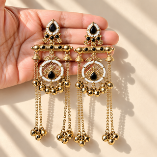 Eldora black Kashmiri earrings with white beads and mehndi Victorian gold finish held in hand