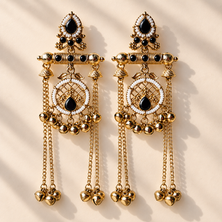 Eldora black Kashmiri earrings laid flat on warm beige background