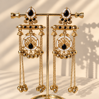 Eldora black Kashmiri long earrings hanging on gold display stand