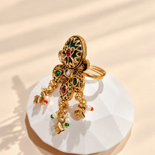 Euphemia multicolour Indian Kemp statement ring in gold finish, ornate green enamel-look centre with red and green stones and white bead dangling charms, image 1