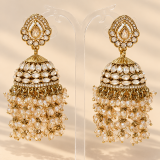 Florence gold polki jhumka earrings on transparent jewellery stand