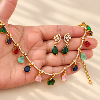 Imogen multicolour Indian imitation necklace set with white CZ stones and matching dark green drop earrings in hand