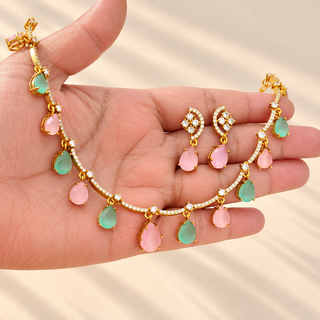 Imogen pastel pink and mint green necklace and earrings displayed in hand