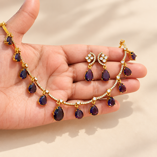Imogen purple artificial diamond necklace and earrings gold finish displayed in hand