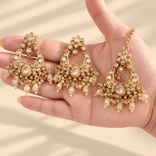 Isadora gold polki choker necklace set earrings and maang tikka shown in hand