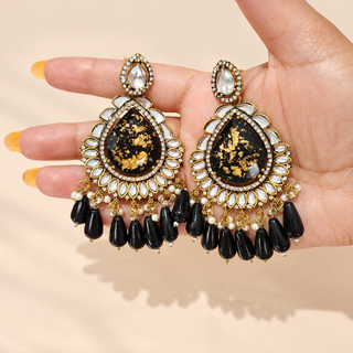 Lavinia black kundan statement earrings 9 cm with clear kundan-style stones and pearl accents shown in hand