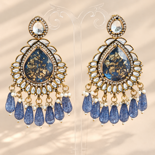 Lavinia blue kundan statement chandelier earrings with gold fleck teardrop centres and blue bead drops on clear display