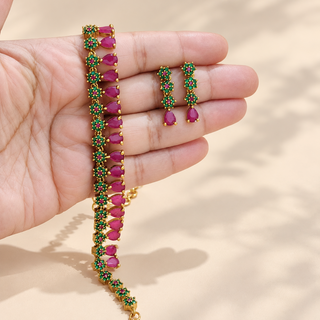 Marigold green and pink necklace set earrings close up on hand