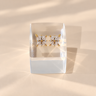 Megan gold finish floral CZ diamond bugadi earrings on acrylic display