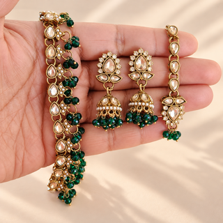 Raya dark green polki necklace set with gold finish jhumka earrings and matching maang tikka close up