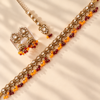 Raya dark red orange Indian imitation polki necklace set with earrings and maang tikka full jewellery view