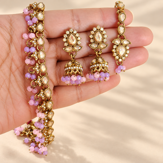Raya multicolour pastel pink lavender polki necklace set earrings and maang tikka shown in hand