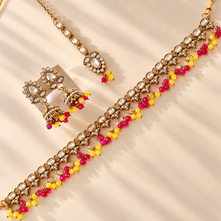 Raya yellow and rani pink polki necklace set in gold finish with matching jhumka earrings and maang tikka