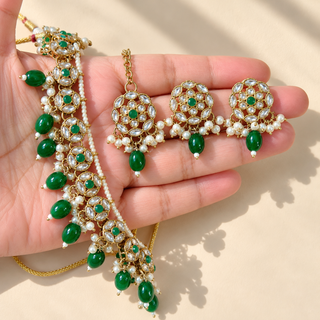 Winifred green kundan necklace set with matching 3 cm earrings and maang tikka close up held in hand
