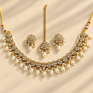 Winifred white kundan Indian necklace set with matching stud earrings and maang tikka on beige background